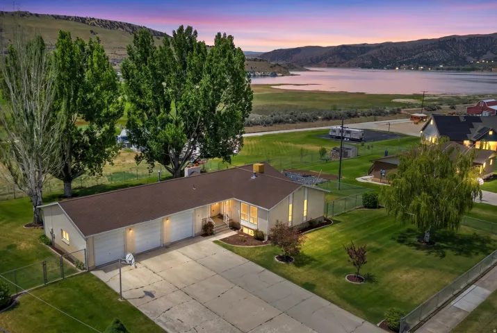 Single-story residence featuring a brown shingle roof and a concrete driveway