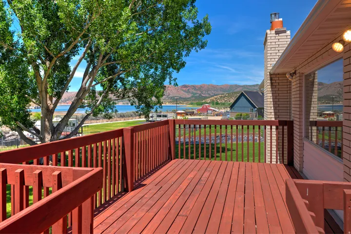 Expansive exterior deck with wood-finish flooring and railings