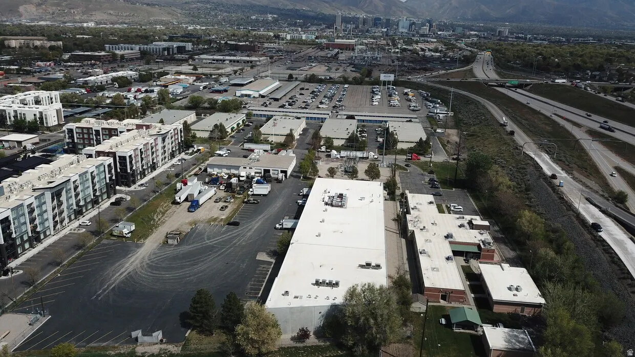 Aerial perspective showcasing commercial properties with expansive paved parking areas