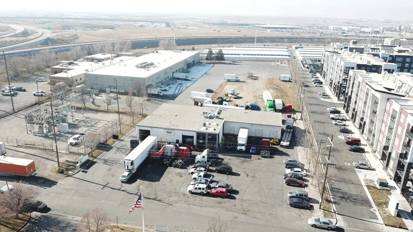 Industrial property featuring multiple loading docks, extensive paved parking, and a large warehouse building