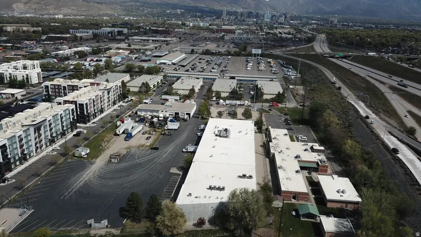 Aerial perspective showcasing commercial properties with expansive paved parking areas