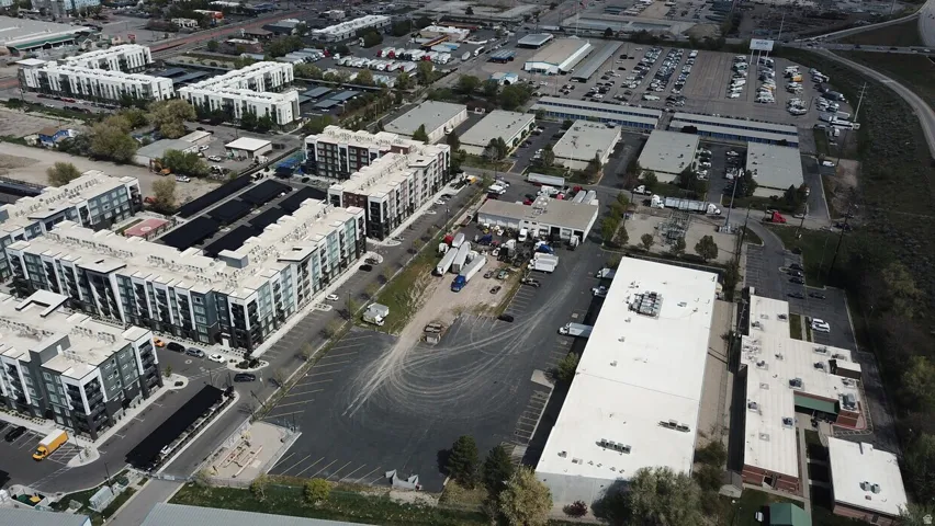 Aerial perspective showcasing a complex of multi-story residential buildings with flat roofs and dark-paneled facades