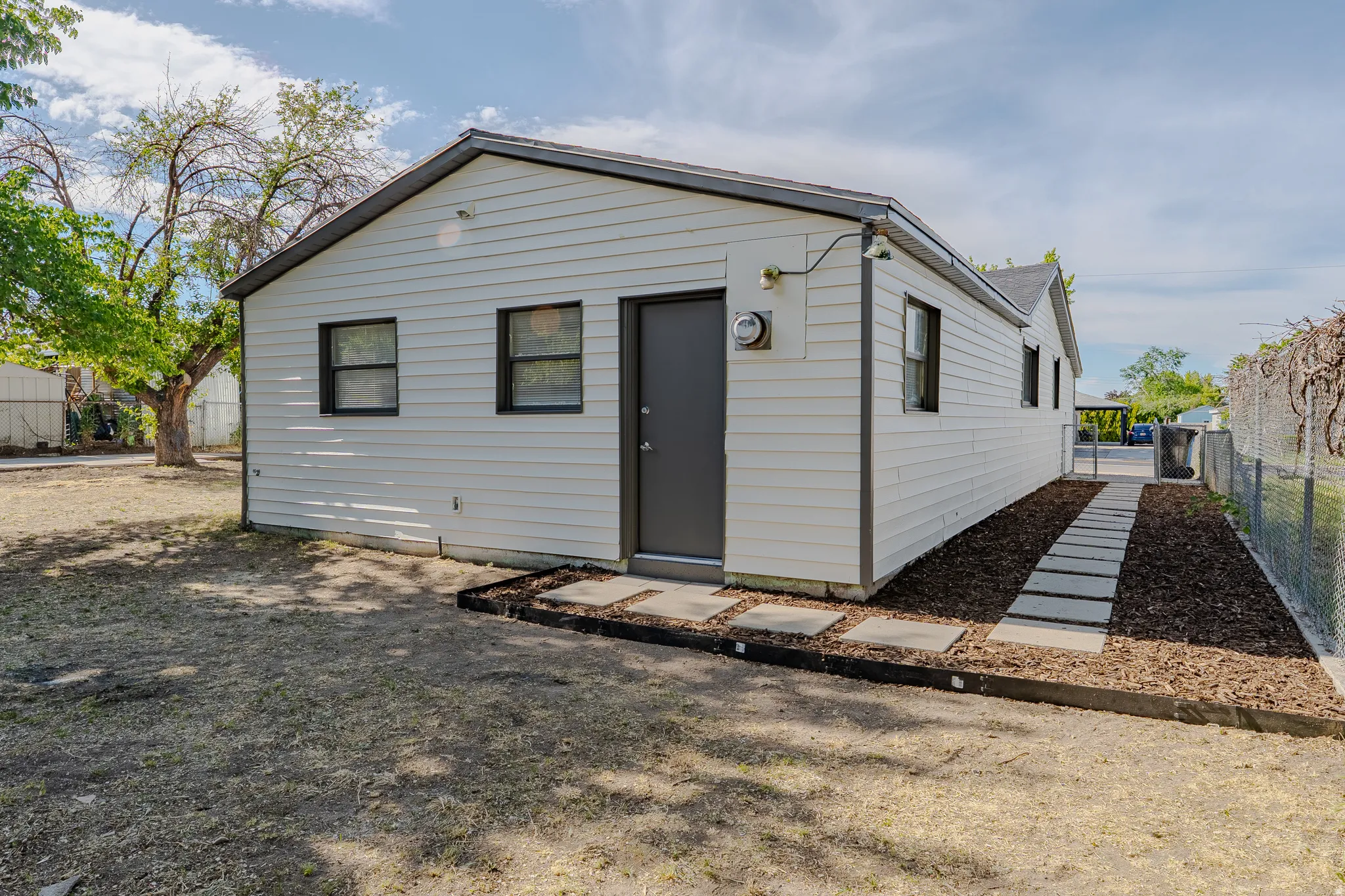White siding exterior with a dark trim roofline