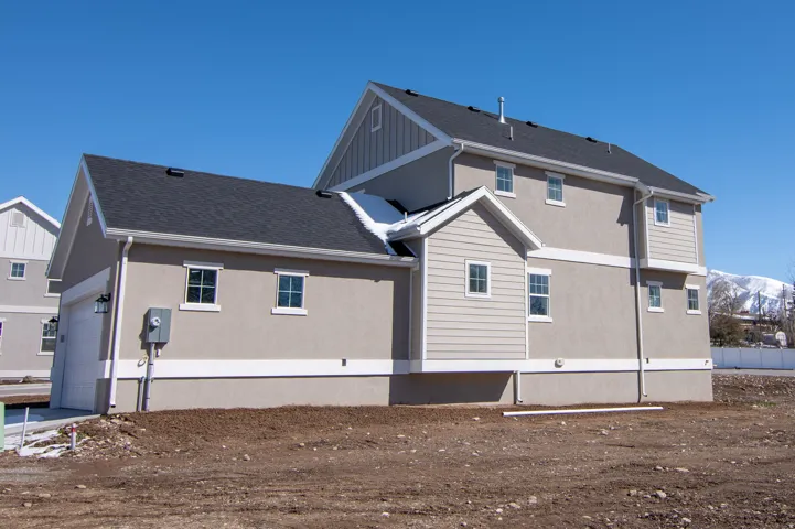 Contemporary two-story residence featuring light beige stucco and horizontal siding