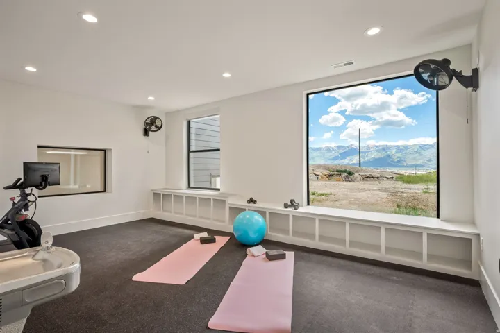 Dedicated exercise space featuring a large picture window showcasing distant mountains