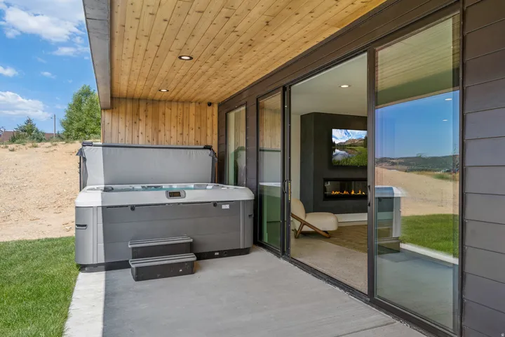 Outdoor patio featuring a hot tub with steps, a wood-finish ceiling, and recessed lighting