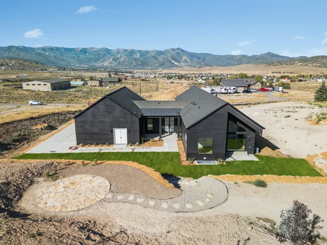 Modern black horizontal siding residence with a dark-pitched roofline