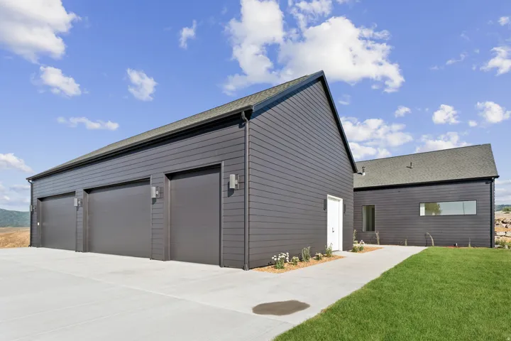 Modern exterior featuring dark gray horizontal siding and a dark roof