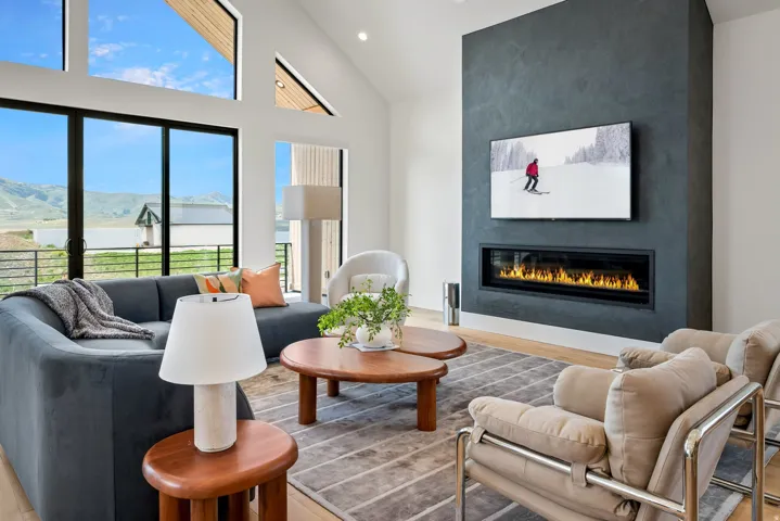 Living area featuring a textured accent wall with an elongated fireplace
