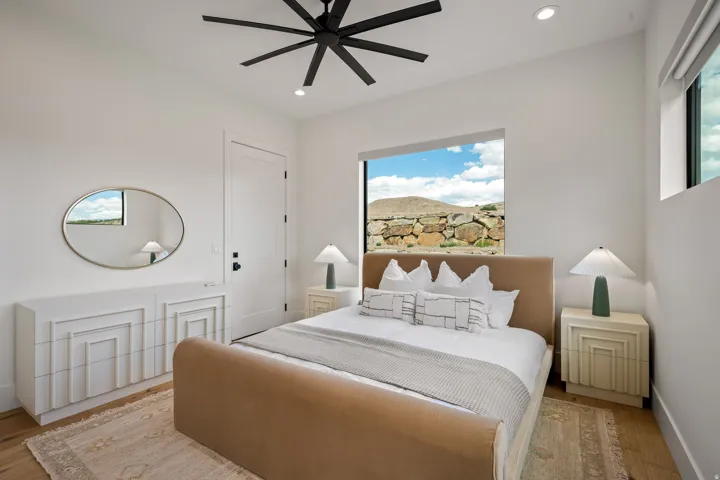 Bedroom featuring white walls, recessed lighting, and a modern black ceiling fan