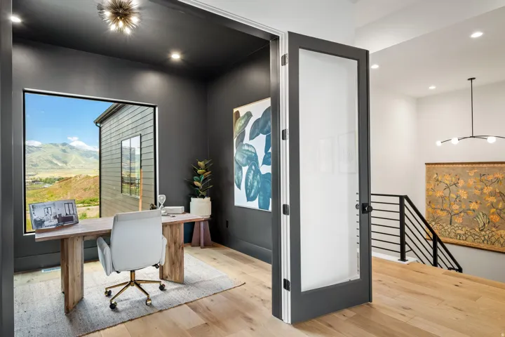 Dedicated room featuring a large picture window, recessed lighting, and wood-finish flooring
