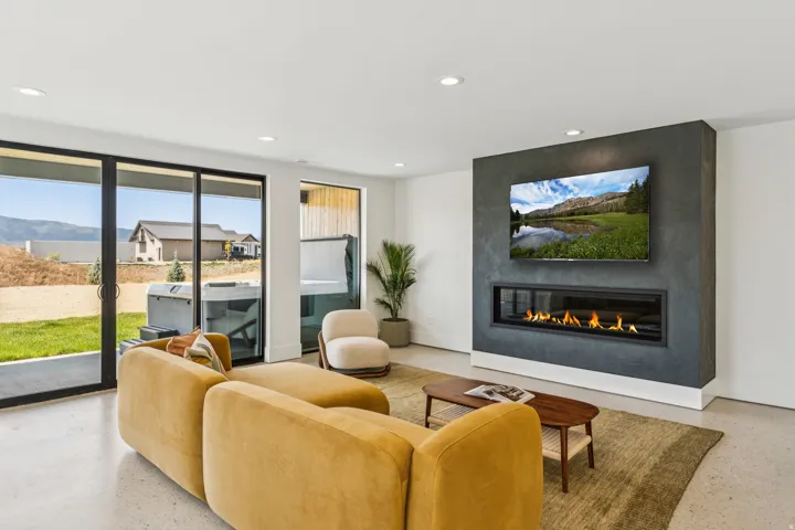 Living area featuring a contemporary linear fireplace set in a textured accent wall