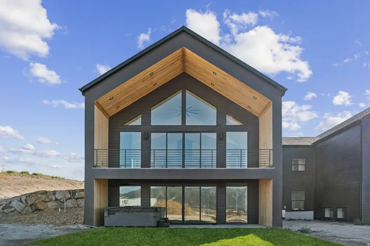 Modern architectural exterior featuring a prominent gabled roofline with wood-finish soffits