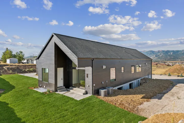 Modern architectural design featuring dark vertical siding and a prominent gabled roofline