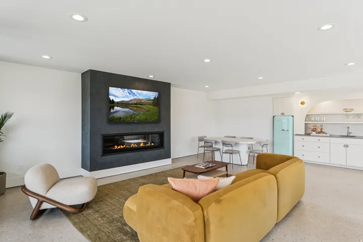 Integrated media wall featuring a wide-screen television and a linear fireplace