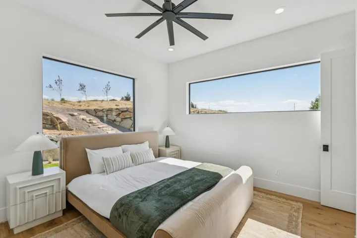 Bedroom featuring light wood-finish flooring and expansive horizontal windows