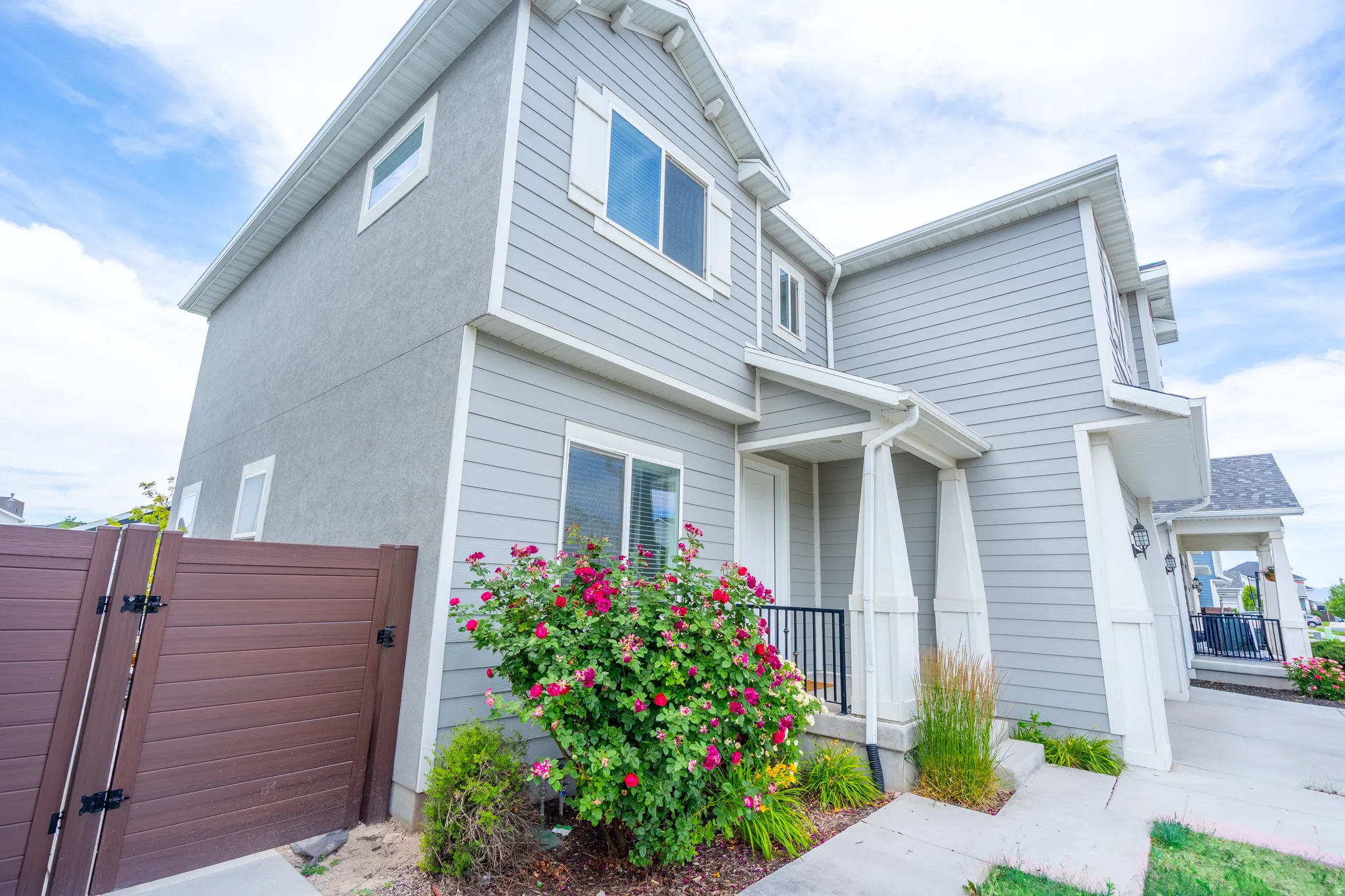 Light gray siding and stucco exterior with white trim