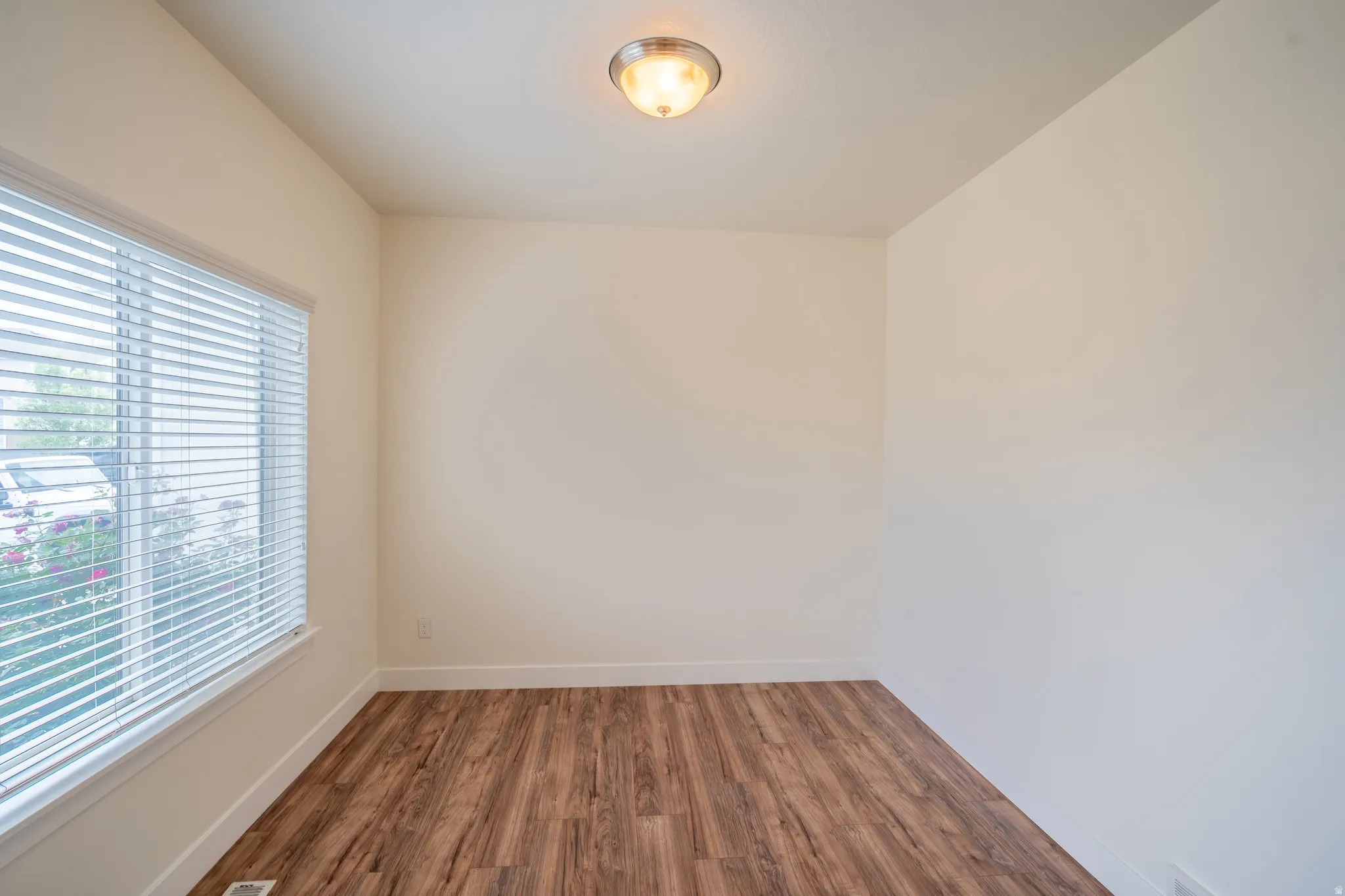 Neutral wall tones with wood-finish flooring