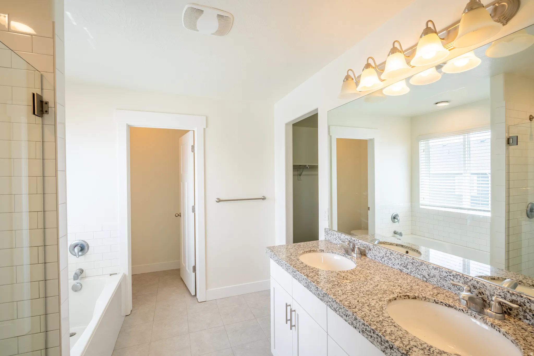 Dual vanity with granite-style countertop and undermount sinks