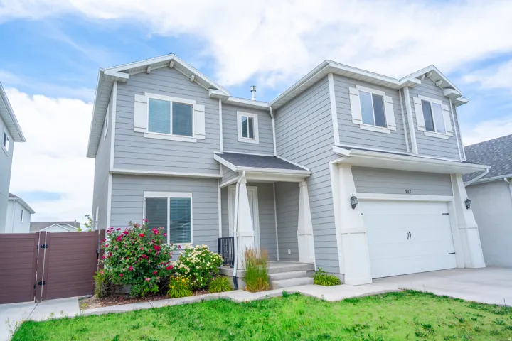 Two-story residential structure featuring light gray siding and white trim