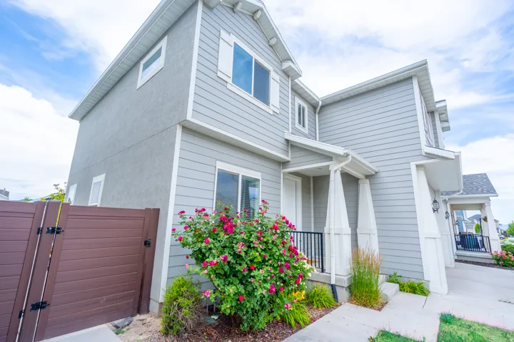 Light gray siding and stucco exterior with white trim