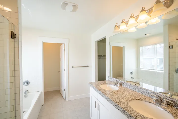 Dual vanity with granite-style countertop and undermount sinks