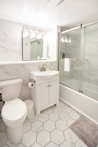 Contemporary bathroom featuring hexagon tile flooring