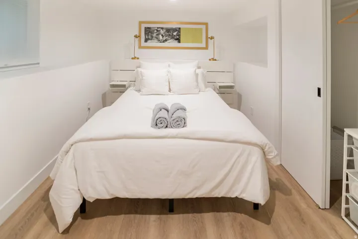 Bedroom featuring light wood-finish flooring, white walls, and a recessed ceiling light