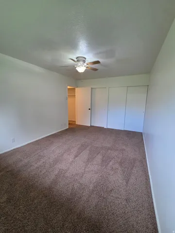 Primary bedroom with his and her closets