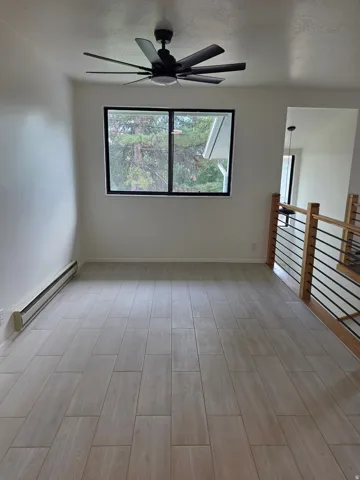 Dining room with new tile flooring and ceiling fan.