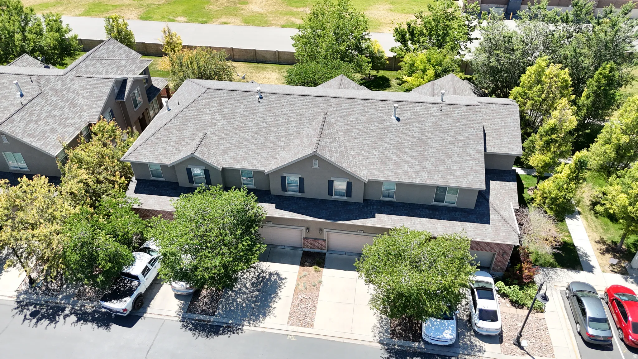 Exterior features include a multi-story design with a shingled roof, neutral-toned siding, and shuttered windows
