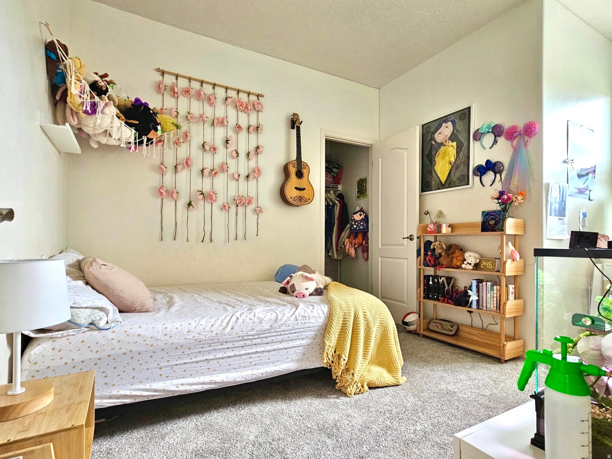 Carpeted room featuring a neutral wall color, white trim, and a built-in closet with a white door
