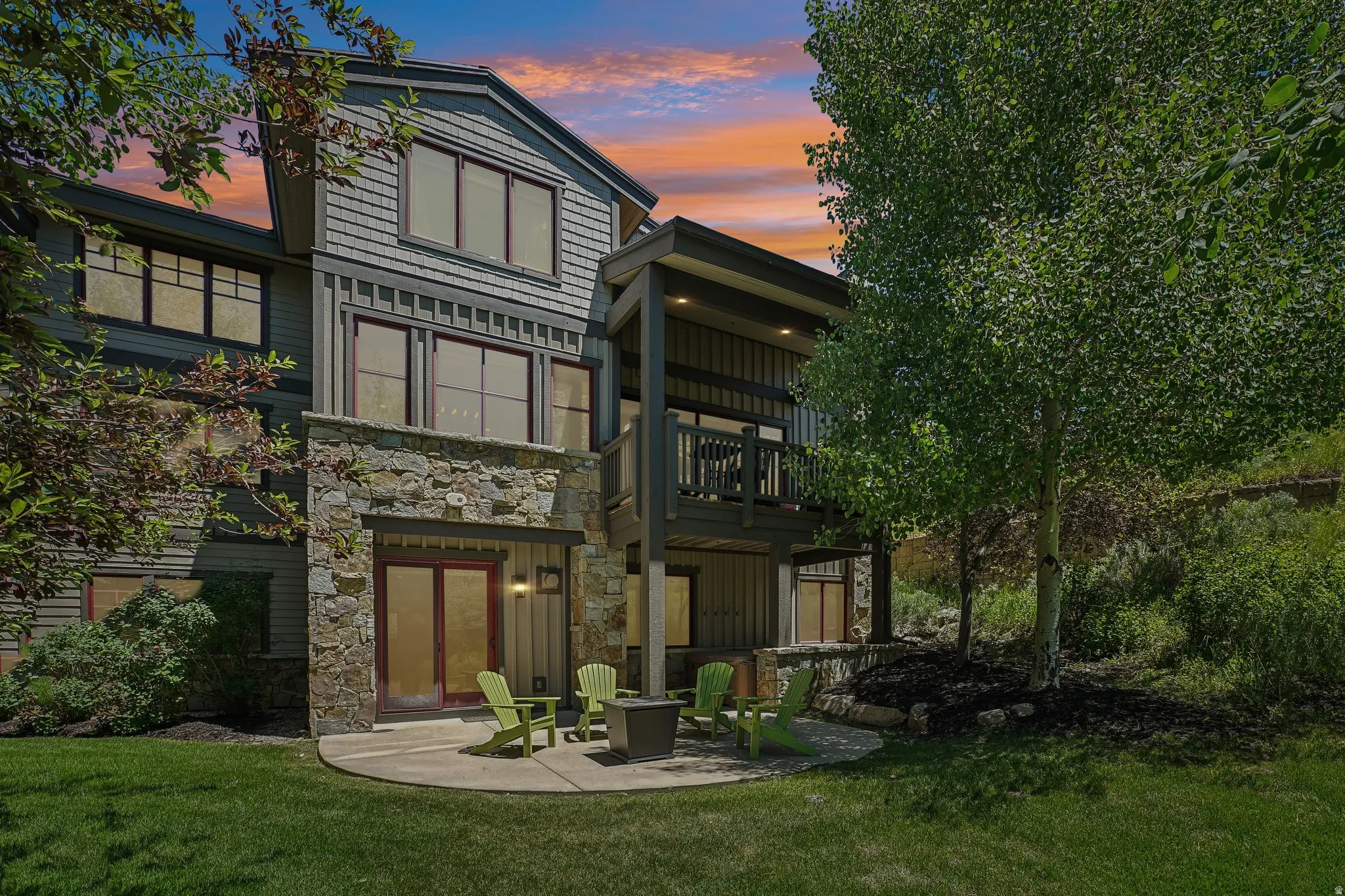 Multi-level exterior featuring stone veneer, horizontal siding, and shake siding