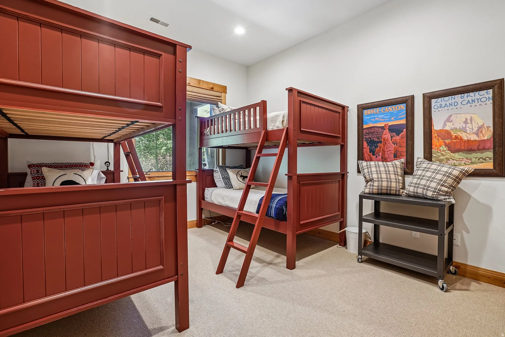 Spacious room featuring light neutral carpeting and white wall finishes