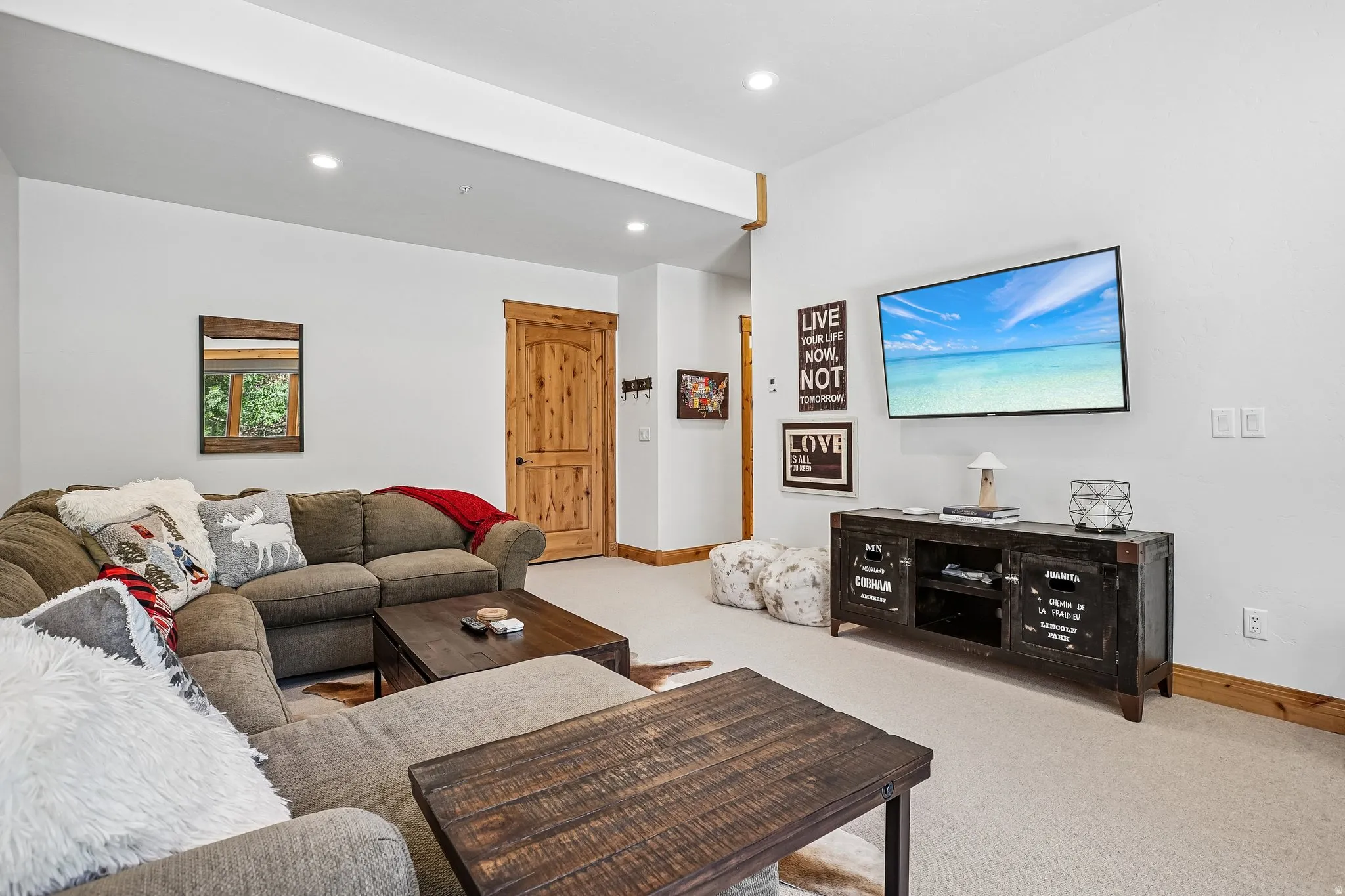 Spacious room featuring light-colored carpet flooring, recessed lighting, and white walls