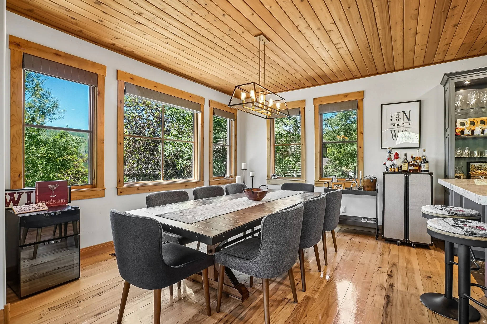 Dining area featuring natural wood-finish flooring and a plank wood ceiling