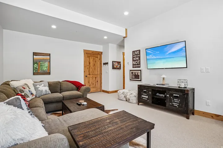 Spacious room featuring light-colored carpet flooring, recessed lighting, and white walls