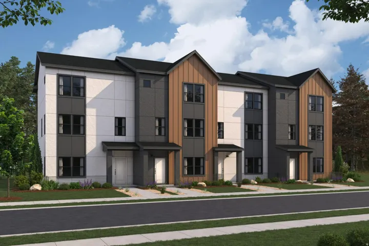 Contemporary townhouse exterior featuring a multi-textured facade with vertical wood-finish siding, white paneling, and dark gray accents
