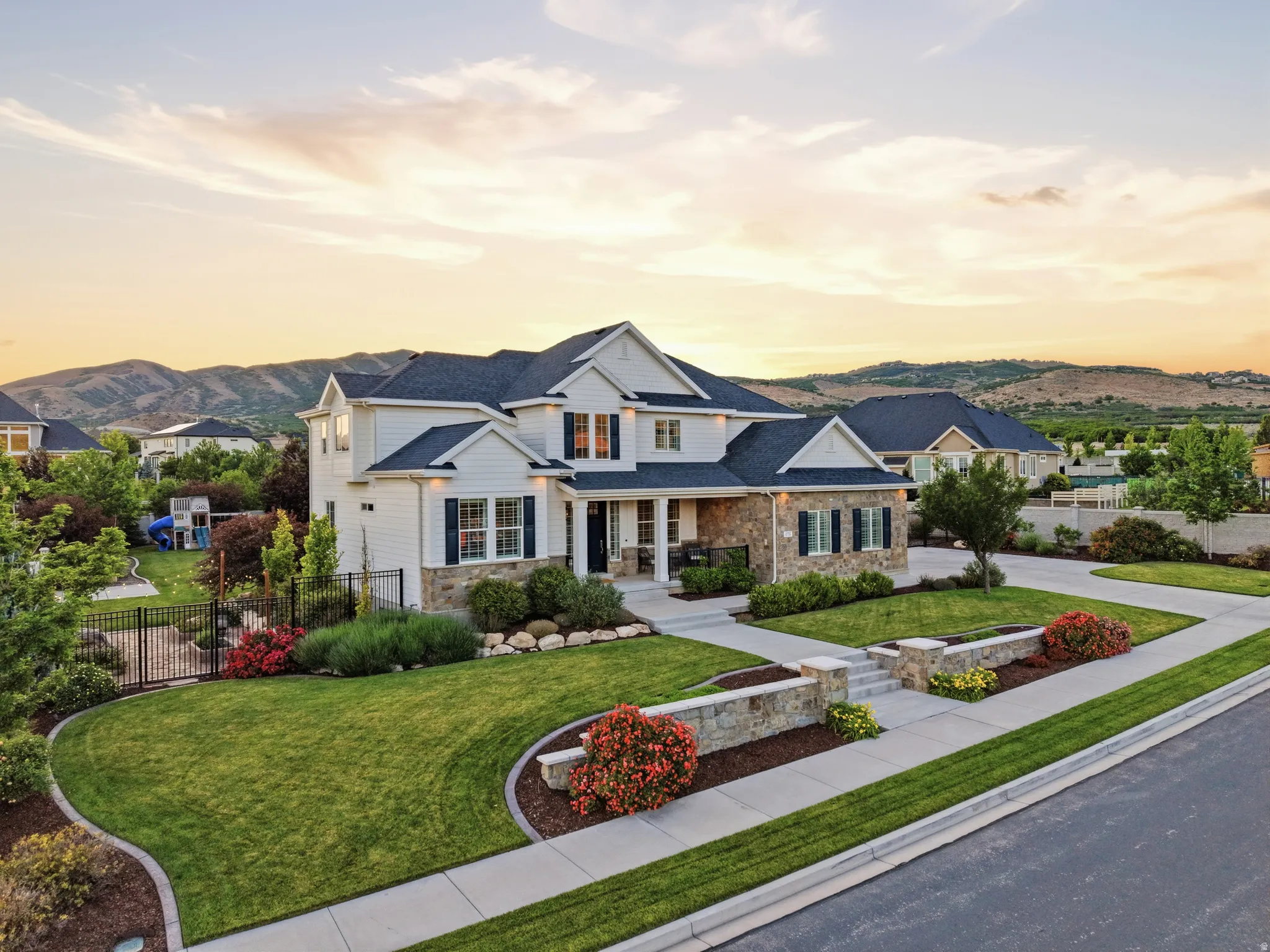Contemporary residence featuring white siding and stone accents