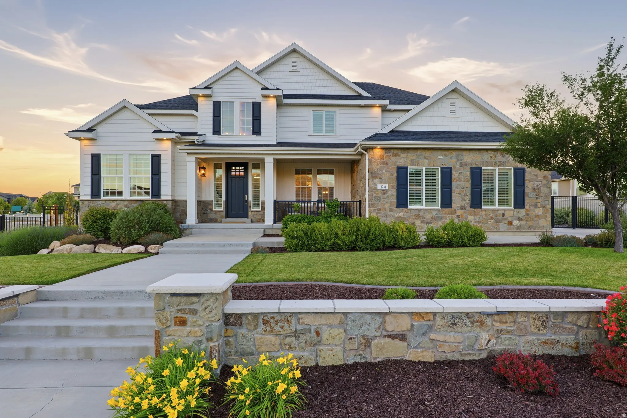 Traditional-style residence featuring a combination of light siding and natural stone masonry