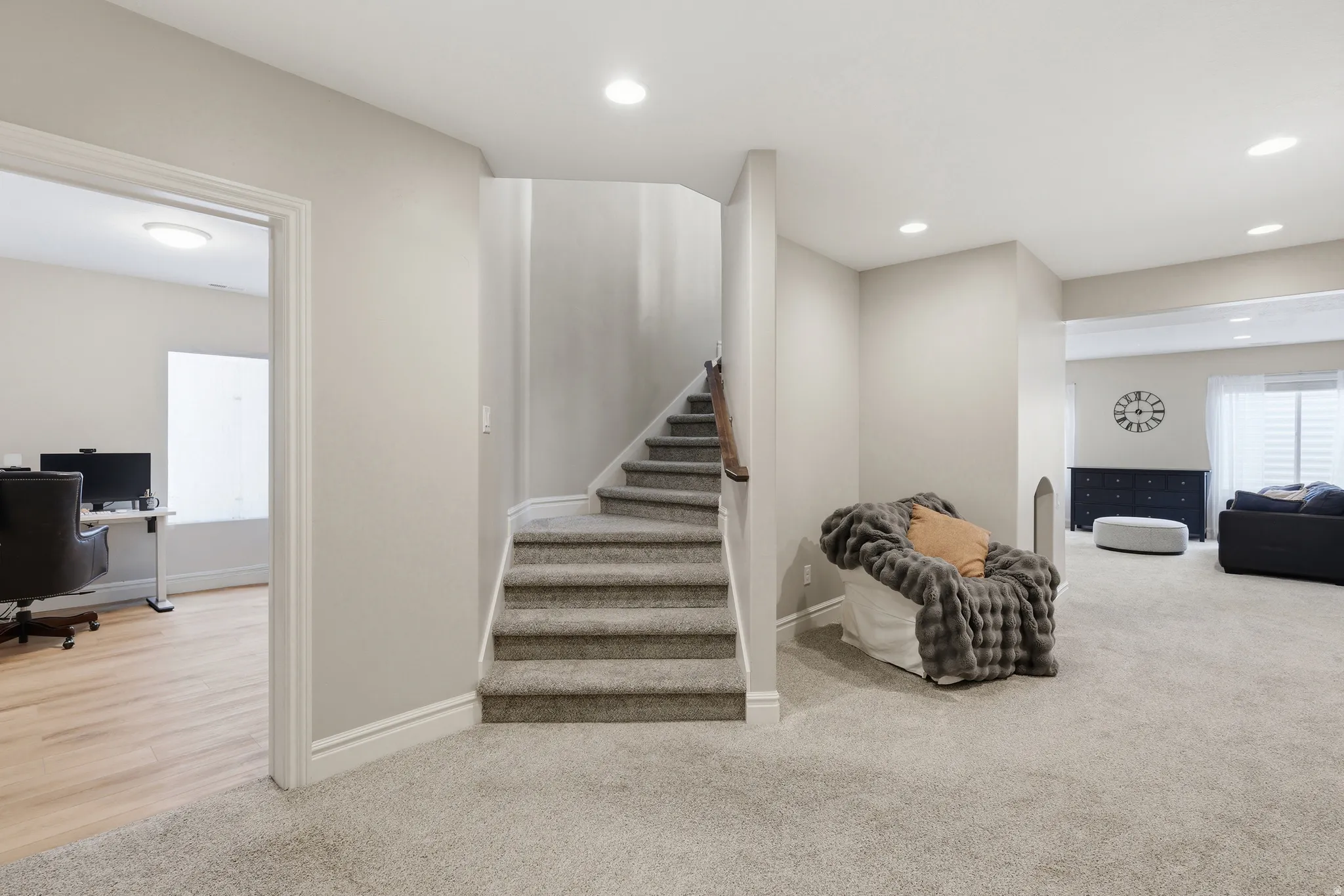 Carpeted staircase with white trim, leading to an upper level