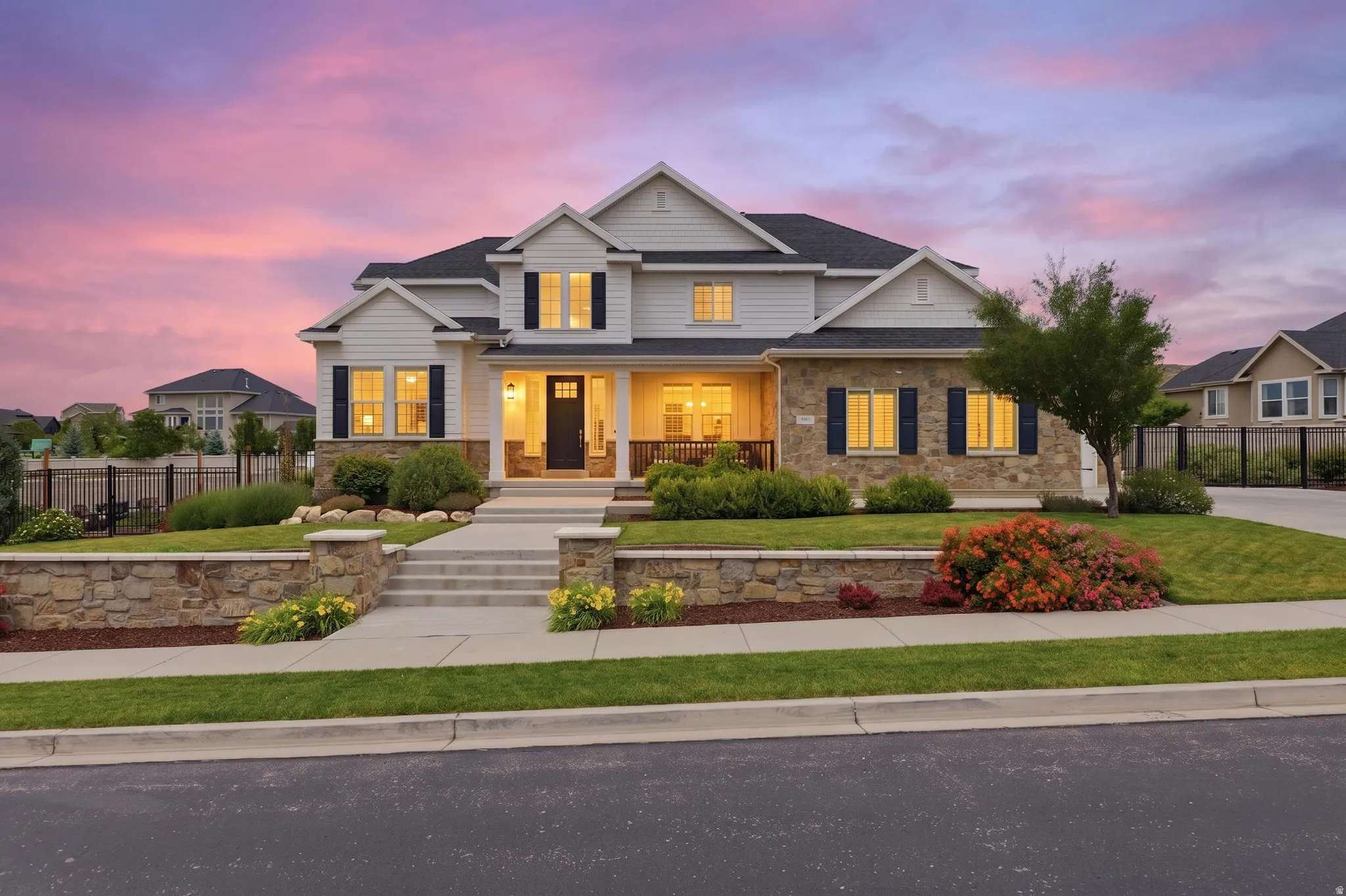 Contemporary two-story residence featuring a stone and siding exterior