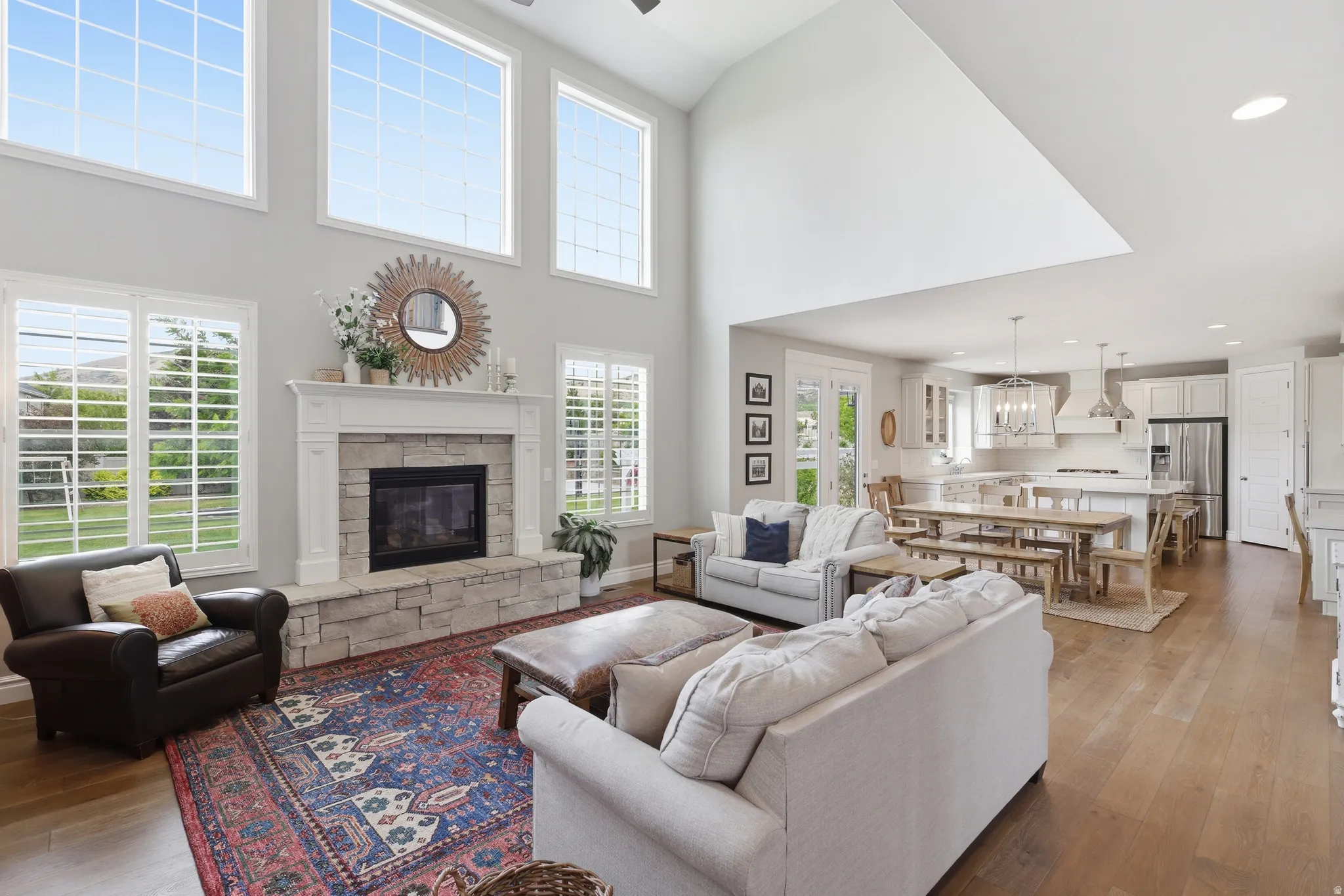 Spacious living area featuring a vaulted ceiling and wood-finish flooring