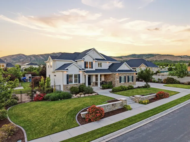 Contemporary residence featuring white siding and stone accents