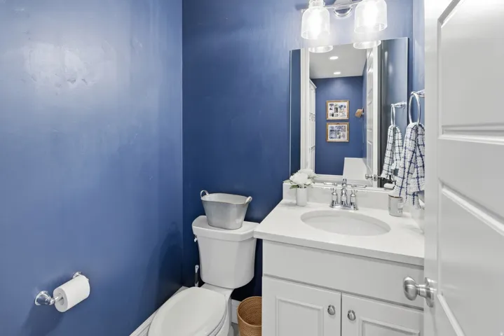 Bathroom featuring a white vanity with an undermount sink, a light-toned countertop, and a chrome faucet