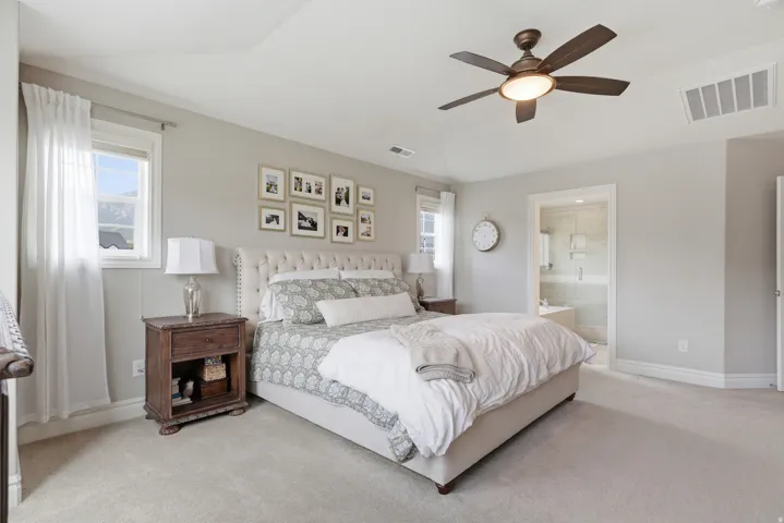 Recessed ceiling with a bronze-finish ceiling fan, neutral wall tones, and plush carpeting