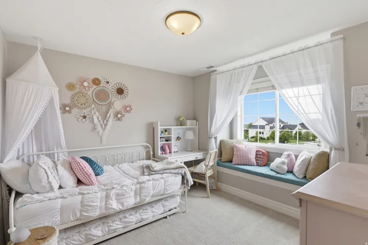 Window seat featuring a light blue cushion and decorative pillows
