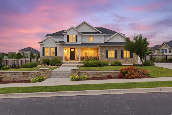 Contemporary two-story residence featuring a stone and siding exterior