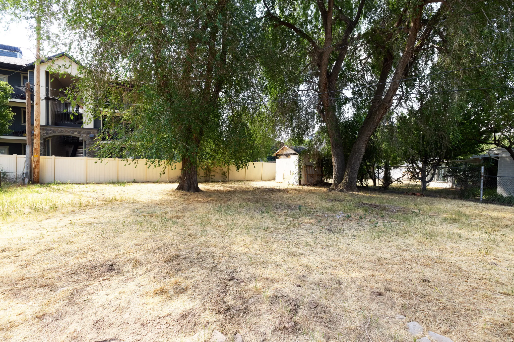 Spacious lot featuring mature trees providing natural shading