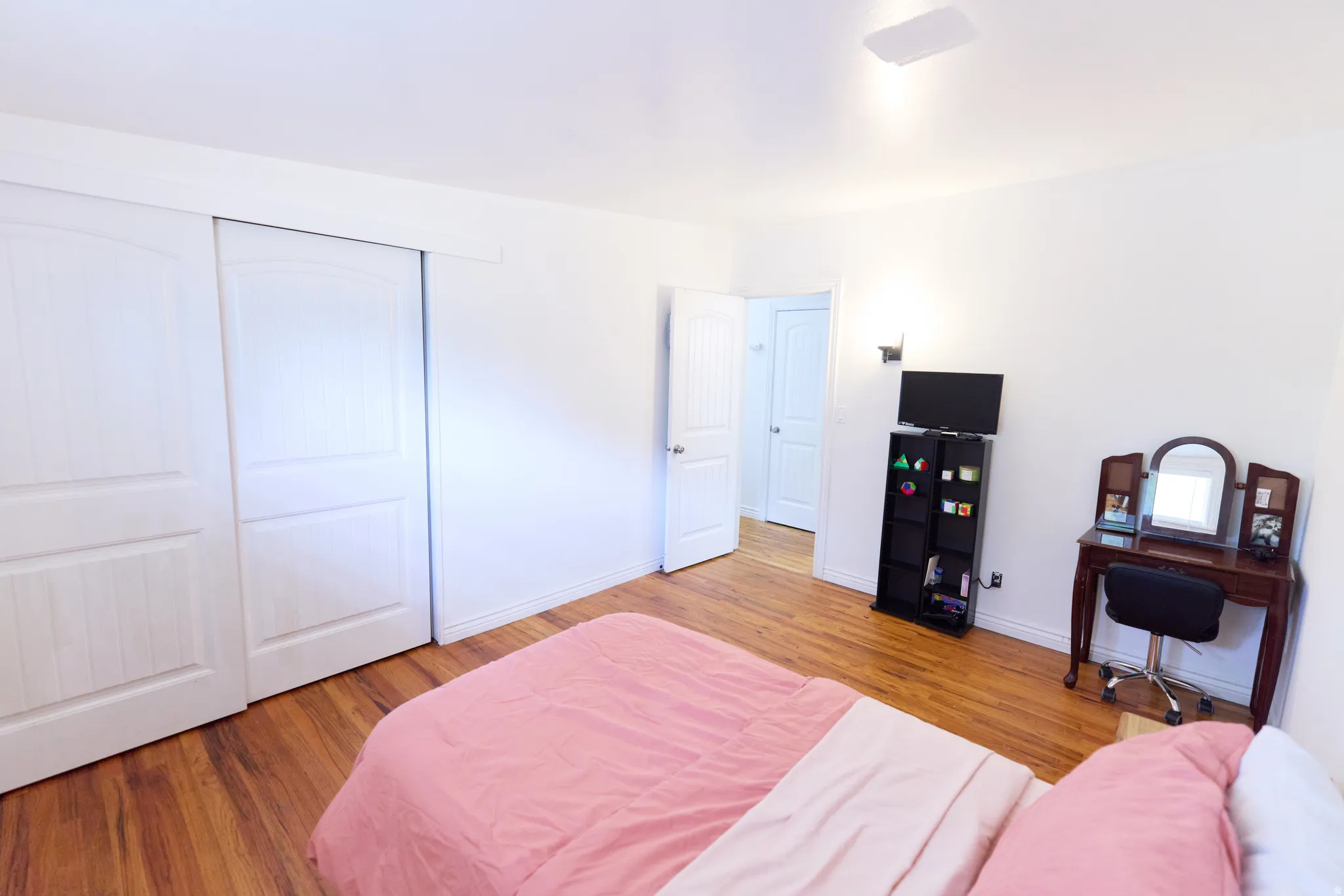 Bedroom featuring wood-finish flooring, white walls, and a white ceiling with recessed lighting